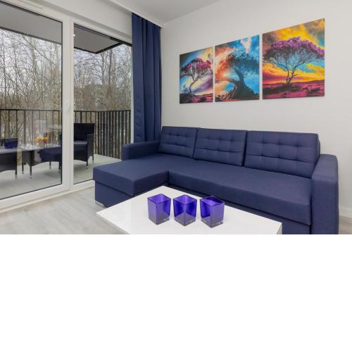 Dark Blue and Grey Apartment with Pastel Bedroom in Warsaw by Noclegi Renters