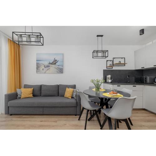 Exclusive and Modern Grey Apartment with Furnished Balcony in Kołobrzeg by Noclegi Renters