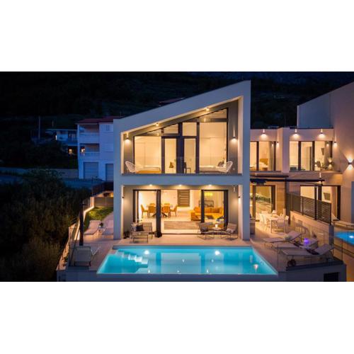 NEW! Three-bedroom Villa Sunshine with a heated pool, media room, and views of the sea