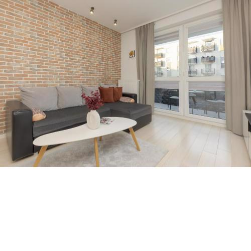 Subtle Colors Apartment in Warsaw with Furnished Balcony by Noclegi Renters