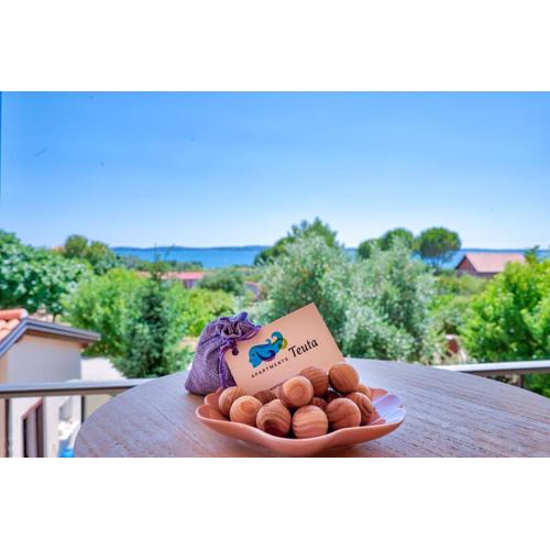 Teuta Apartments - a beach and a sea view